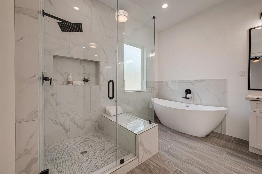 Custom walk-in shower with seat and a soaking tub.