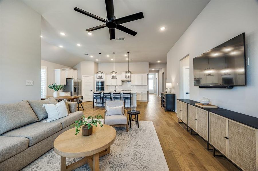 Living room with a fireplace and ceiling fan