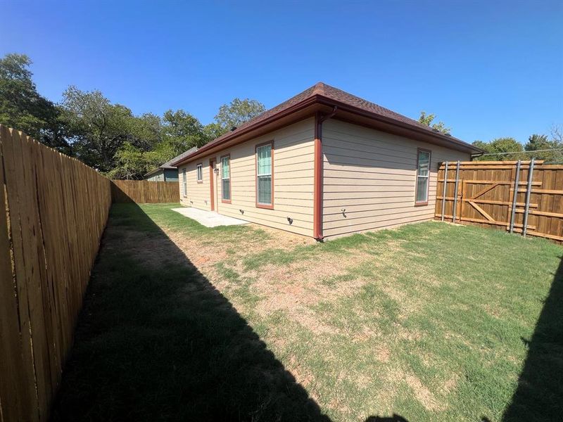 View of side of home with a lawn