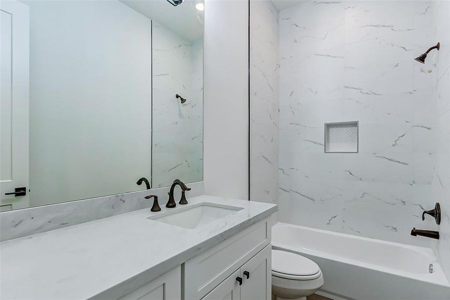 This home features 3 FULL bathrooms! Each bathroom features upgraded white cabinetry, coordinating white counters, and oil rubbed bronze fixtures. This bathroom features a tile surrounded tub/shower combo.