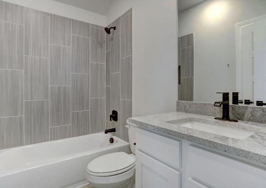 Secondary bath with a dual shower and tub.