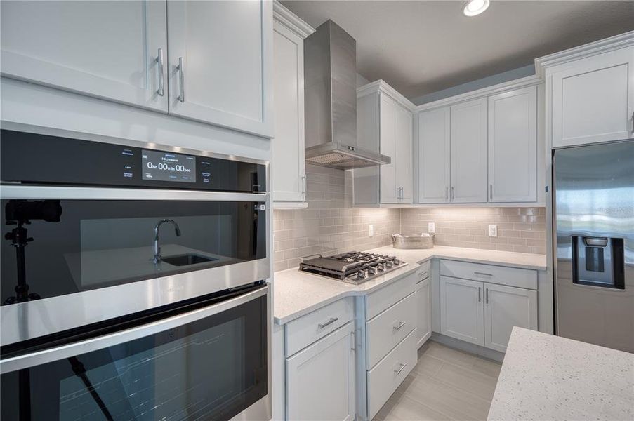 Kitchen: The built in oven and microwave along with the gas cooktop and SS vent give this kitchen a lovely custom feel.