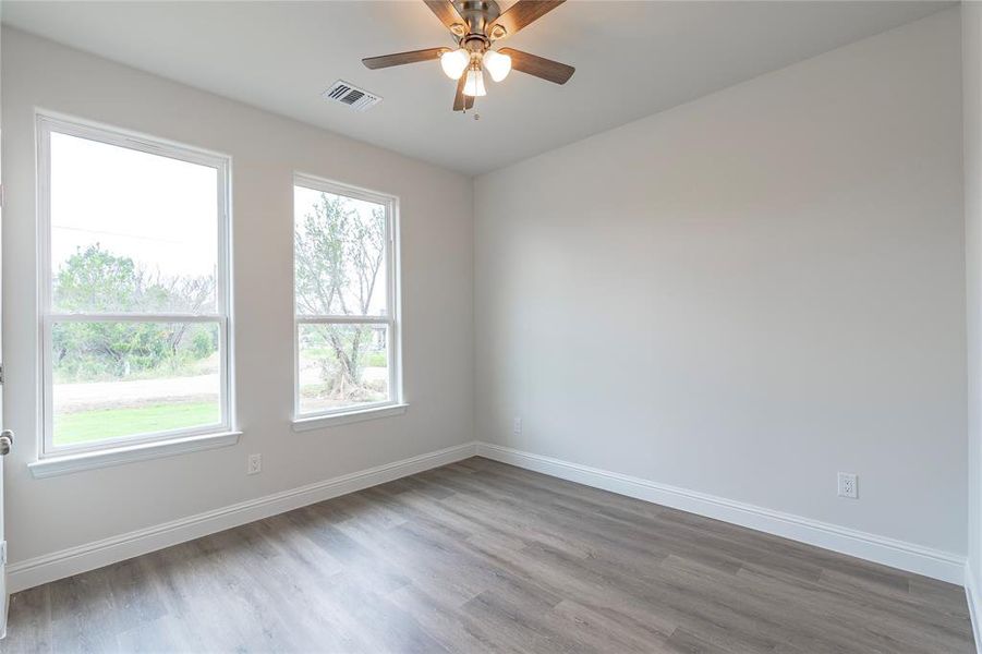 Unfurnished room featuring ceiling fan and hardwood / wood-style floors