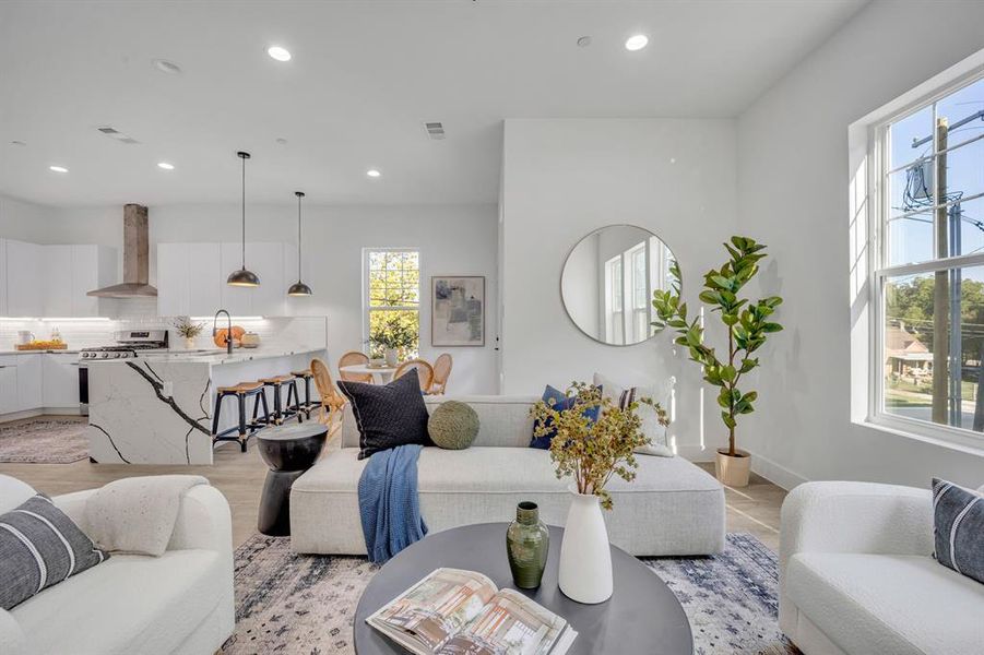 Living room featuring light wood-type flooring and sink