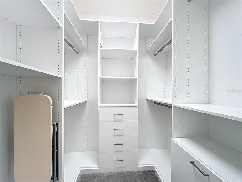 custom closet with outlet and ironing board