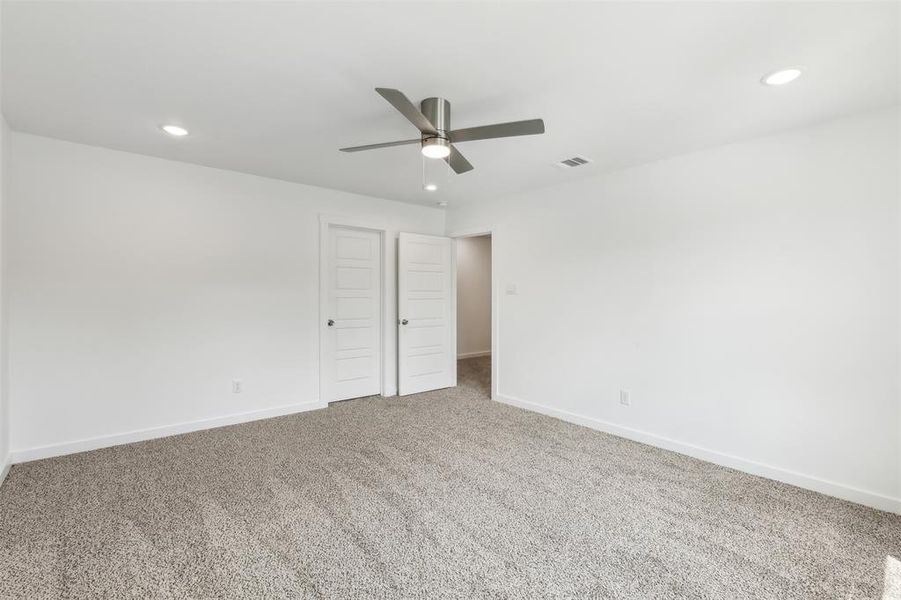 Unfurnished bedroom featuring carpet and ceiling fan