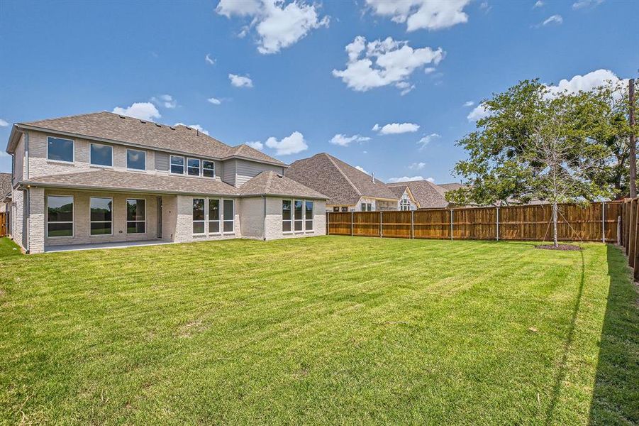 Rear view of house featuring a yard