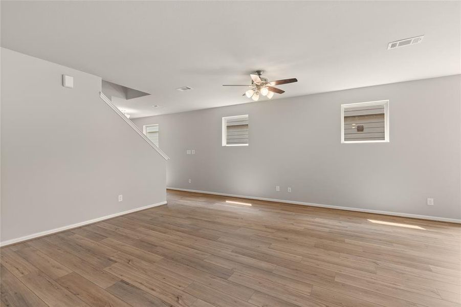 Your family room has ample space to entertain family and friends. This space features beautiful floors, fresh paint, ceiling fan with lighting, and high ceilings.