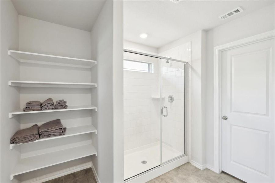 Bathroom featuring a shower with door