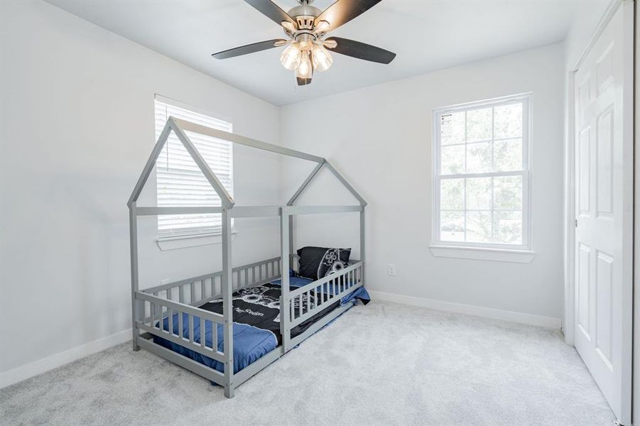 Bedroom featuring light carpet and ceiling fan