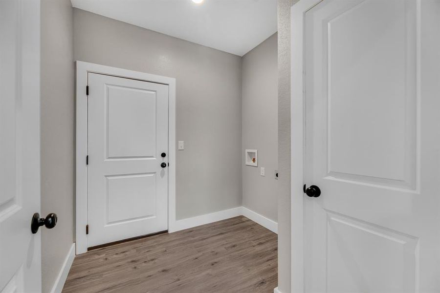 Laundry room featuring light hardwood / wood-style flooring and washer hookup