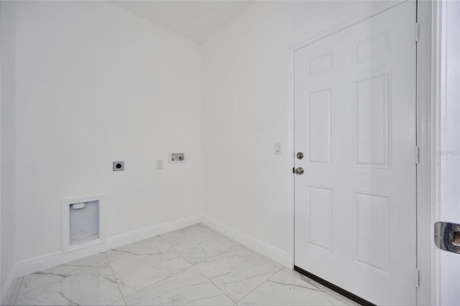 Laundry area.  Door leads out to the garage