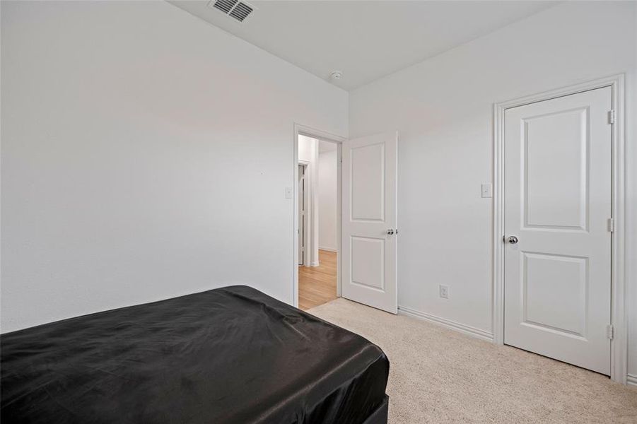 Bedroom with light carpet