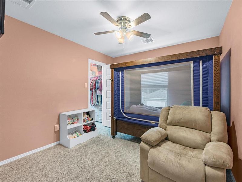 Your secondary bedroom features plush carpet, fresh paint, ceiling fan with lighting, and a large window that lets in plenty of natural lighting.