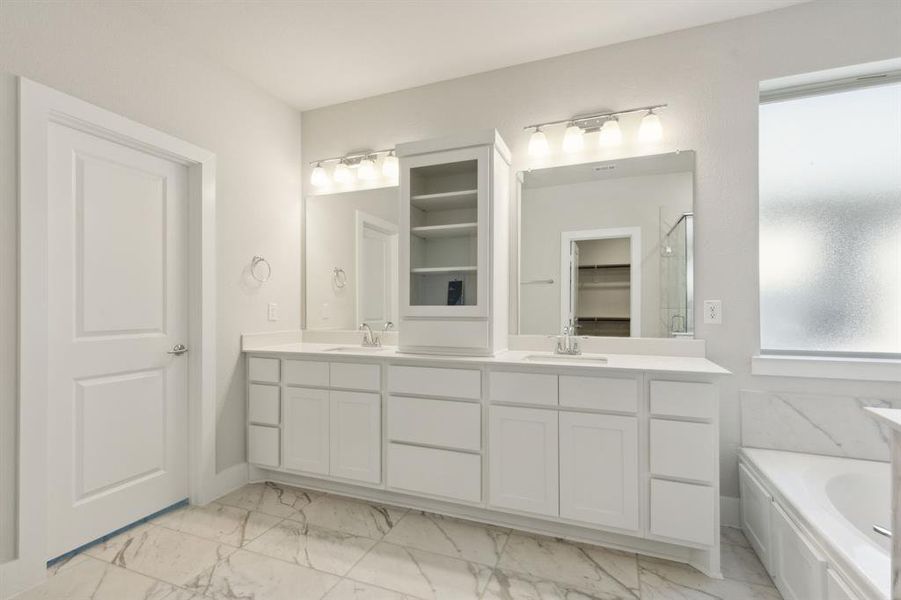 Bathroom with a tub to relax in and vanity