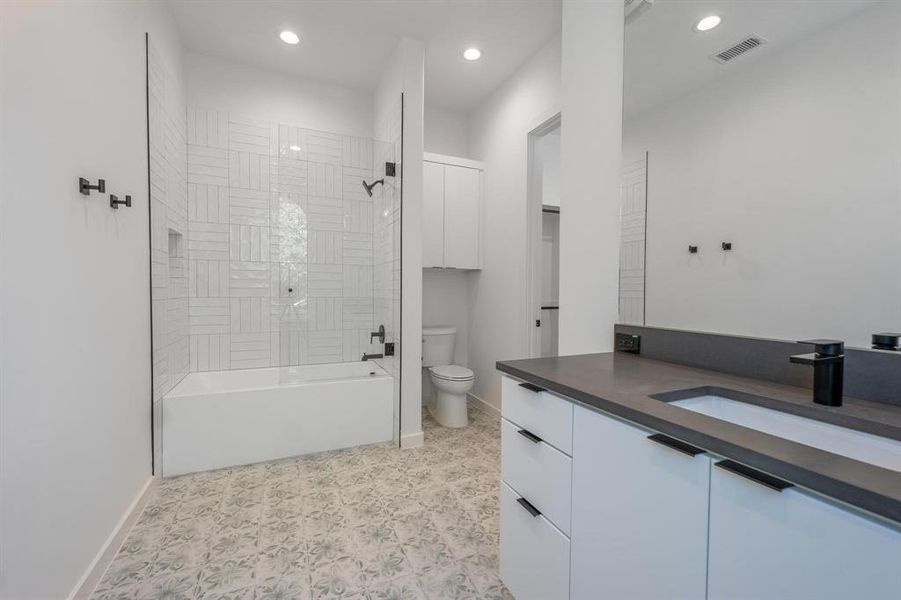 Full bathroom featuring toilet, shower / washtub combination, and vanity