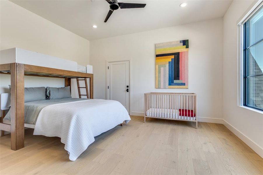 Bedroom with ceiling fan and hardwood / wood-style flooring