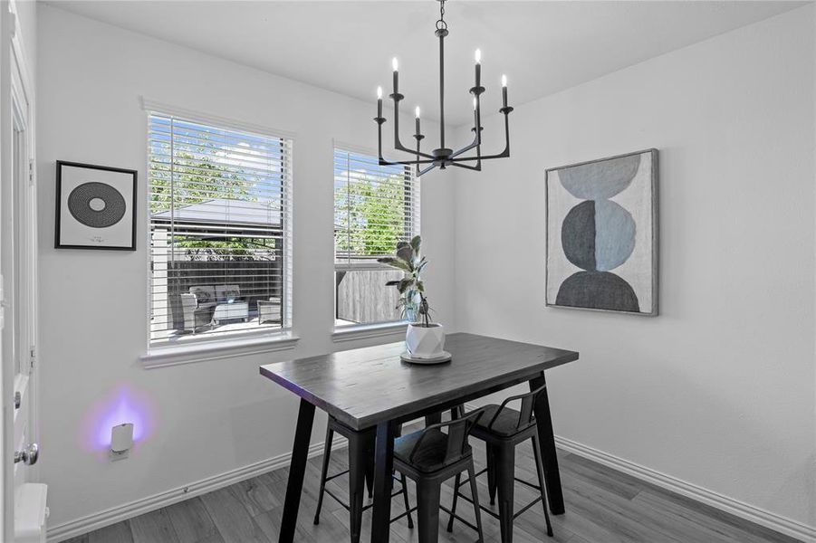 Dining room featuring an inviting chandelier and dark wood-type flooring