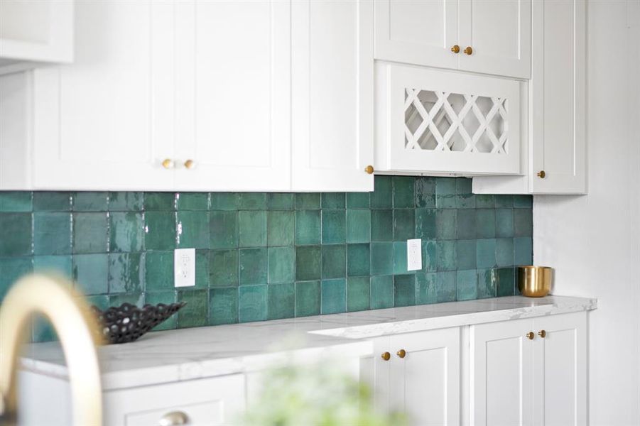 Custom painted upper and lower cabinets with built in designated wine rack.