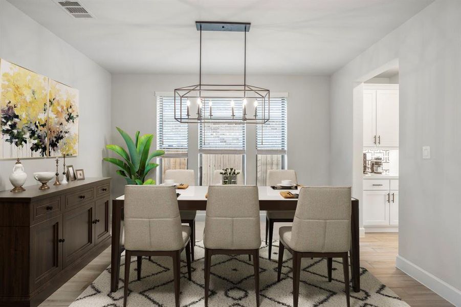 Make memories gathered around the table with your family and friends! This dining room features high ceilings, wood tile flooring, large windows, and a beautiful chandelier! *This room has been virtually staged