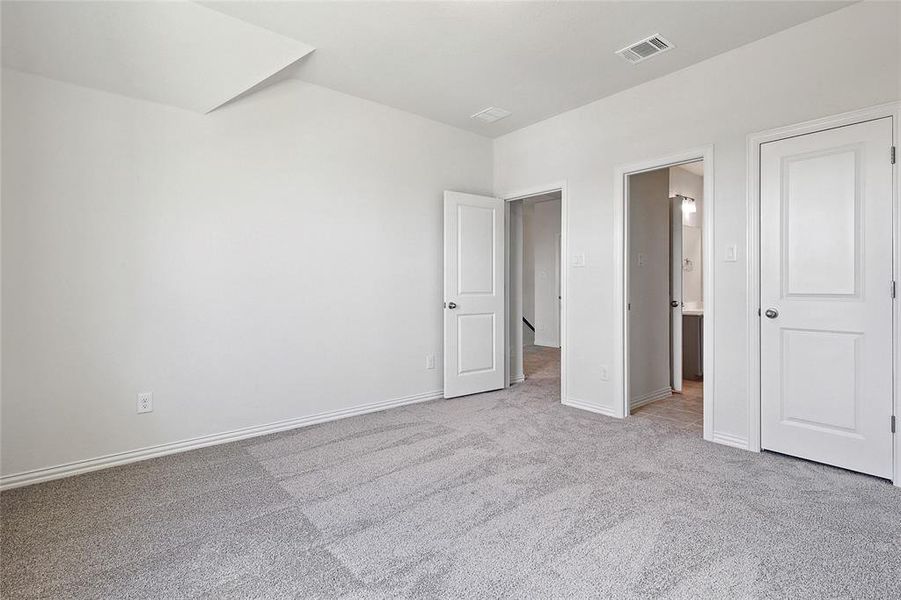 Unfurnished bedroom featuring light colored carpet