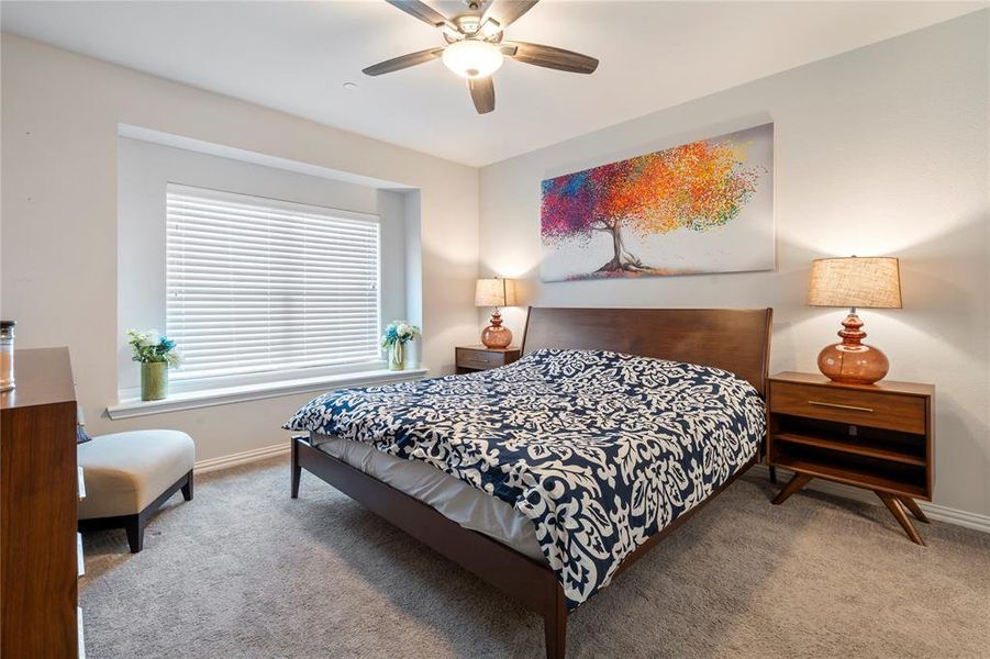 Primary bedroom is perfection with neutral tones, fan, oversized window for natural light, and its own en suite.