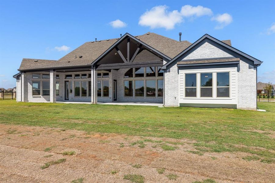 Back of house with a patio and a yard