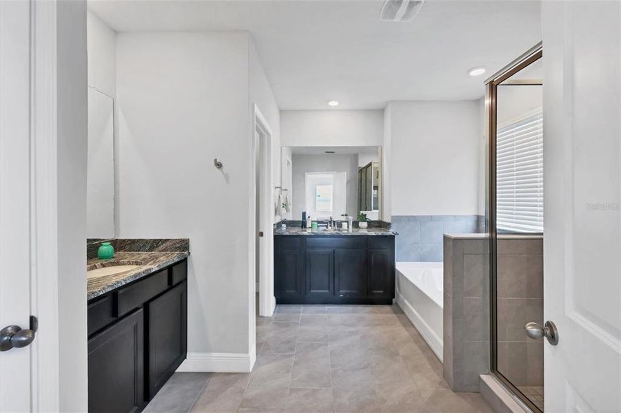 Ensuite Master Bath with split vanities, garden tub, walk in shower, linen closet and private toilet room!