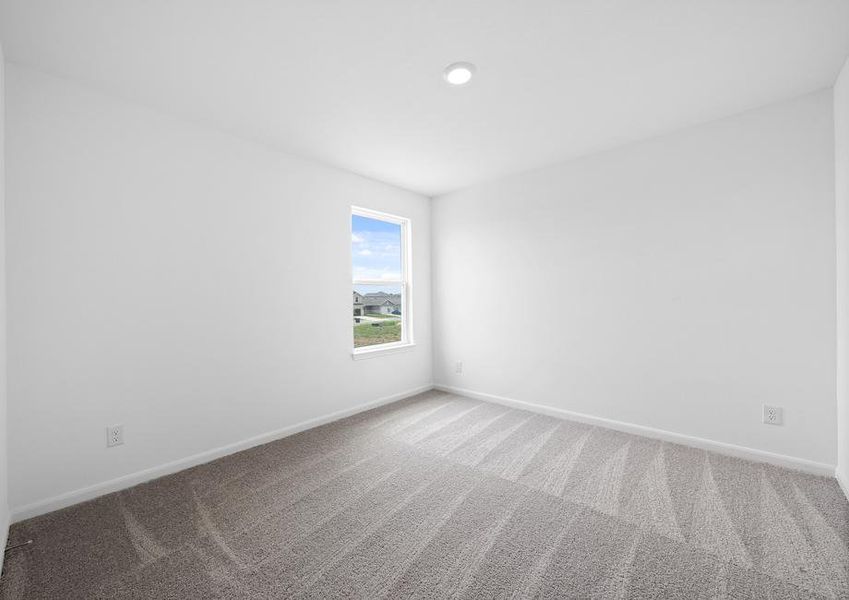 Guest bedroom with a window that allows natural light in.