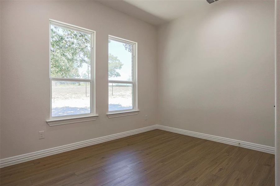 Unfurnished room featuring dark hardwood / wood-style flooring