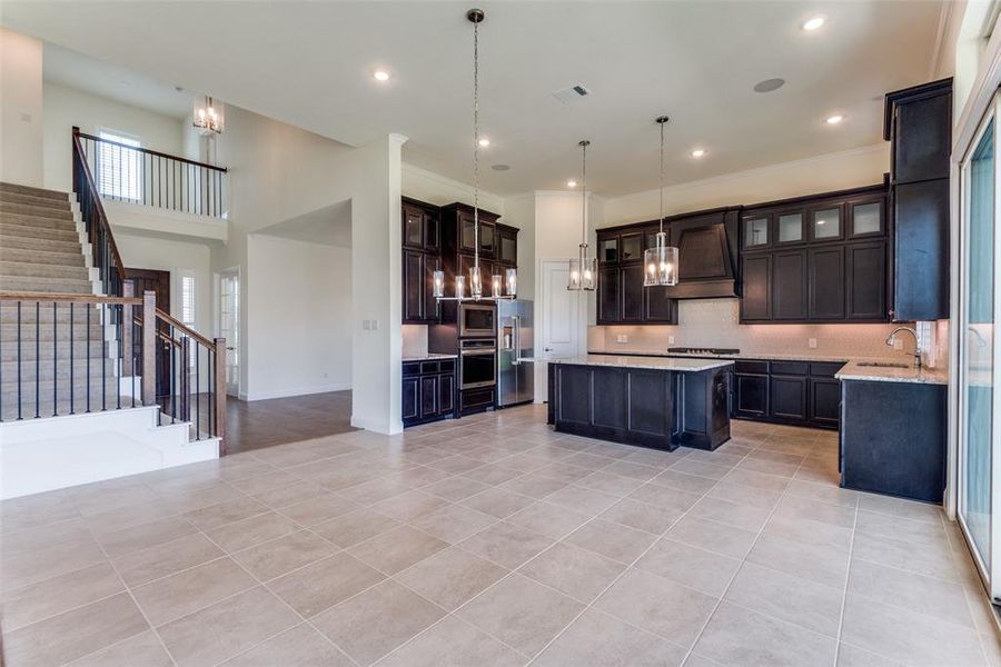 Grand entry, foyer, study with French Doors, dining room with water views, kitchen with water views, staircase....gorgeous kitchen cabinetry and pendant lights over the island.