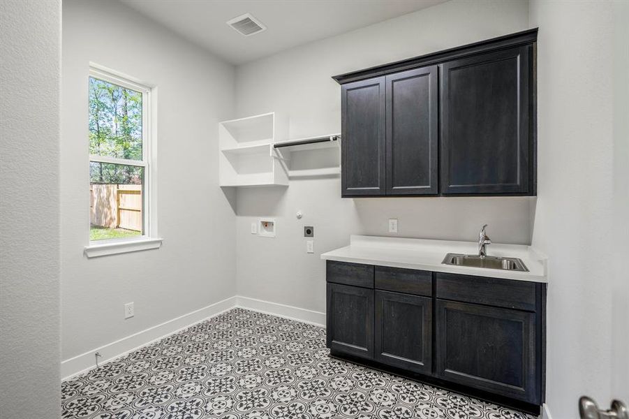 Doing laundry might just become your new favorite chore! High quality cabinets and chic patterned flooring combine practicality with impeccable design.