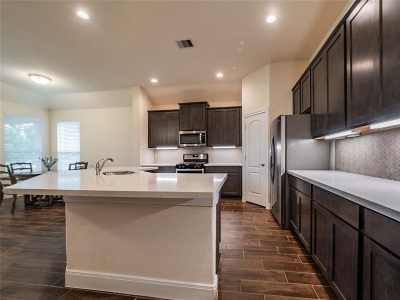 here you can see how it all flows together, great for entertaining, all appliances come with the home including the refrigerator ,you have under counter lighting , the chef of the home will not be disappointed with this kitchen