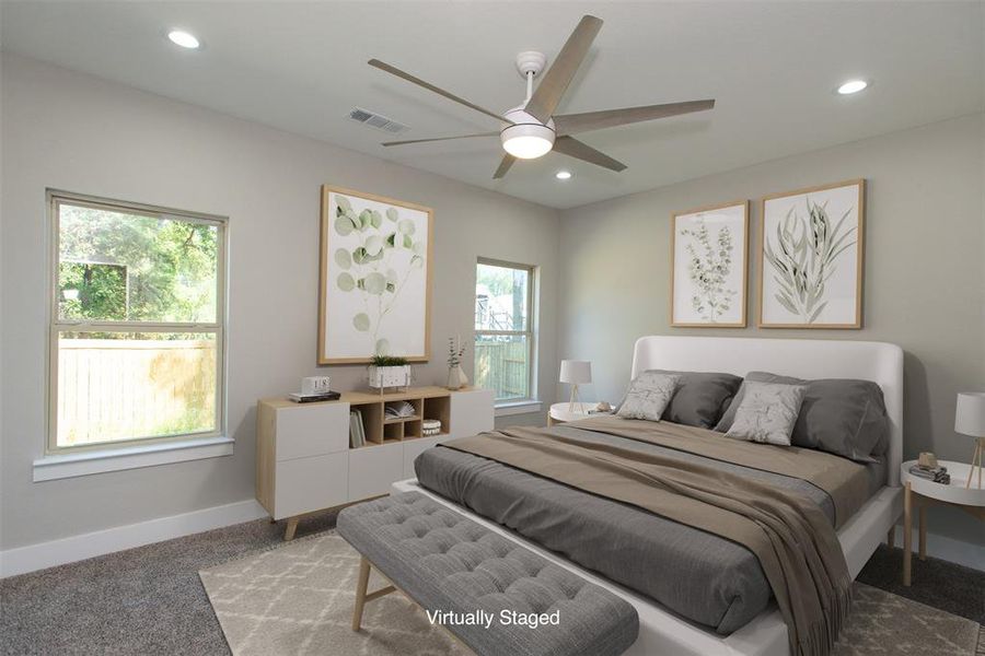 Carpeted bedroom with ceiling fan and multiple windows