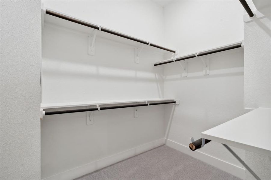 The walk-in closet, with shelving throughout, transforms storage into a dreamlike experience.