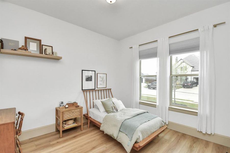 Bedroom 1 located at the front of the home, offers a walk in closet and adjoining Jack and Jill full bathroom.