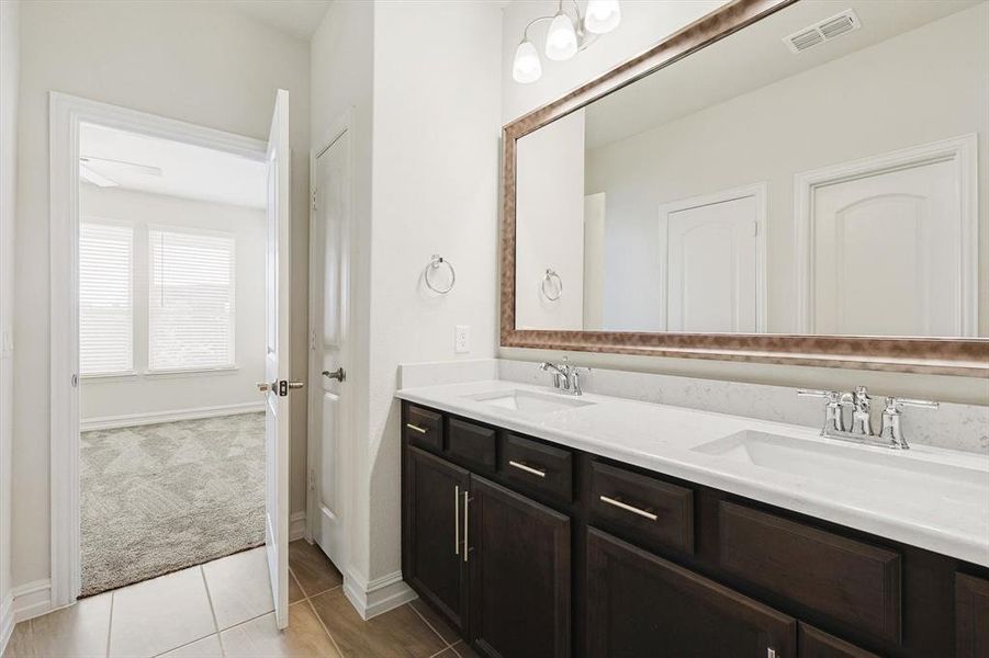 Bathroom with tile patterned flooring and vanity