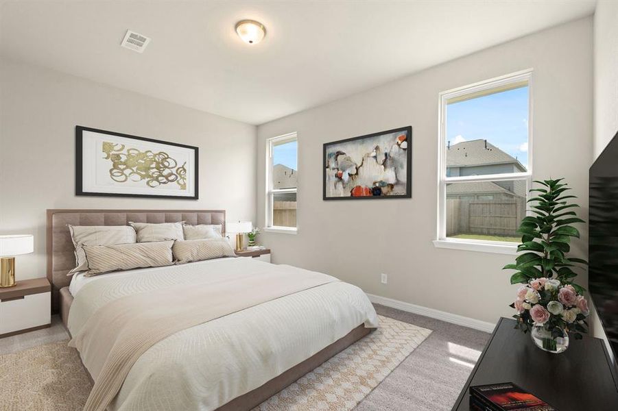 The primary bedroom is generously sized, creating a tranquil and spacious retreat that offers ample room for relaxation. Featuring plush carpet, high ceilings, fresh paint, and large windows that lets in natural lighting throughout the day.