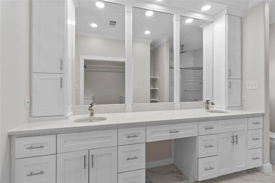 Primary bathroom with lots of storage and custom framed mirrors