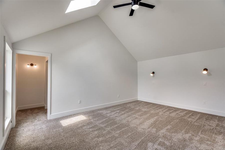 Primary bedroom with its vaulted ceilings, brand new windows, and HUGE closet is an amazing place to retire to at the end of the day!   This bedroom faces the massive backyard.
