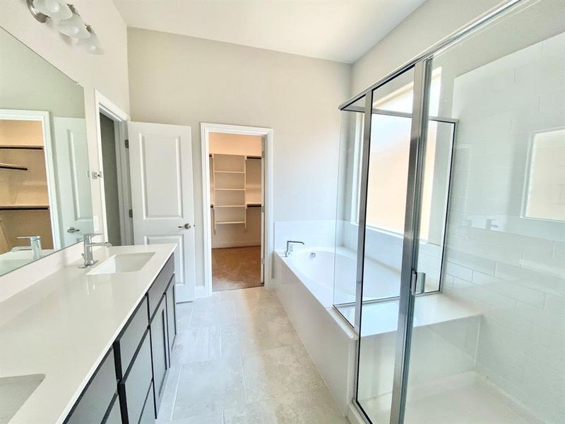 Bathroom featuring vanity, plus walk in shower, and tile patterned flooring