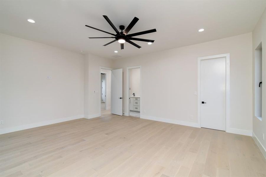 Spare room with ceiling fan and light wood-type flooring