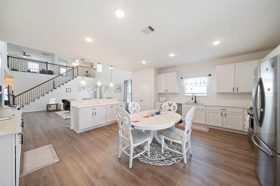 Another view of this spacious kitchen.  Pantry is the double doors behind the kitchen table.  Cabinet pulls have been added to these gorgeous Shaker cabinets for a very current and updated look!