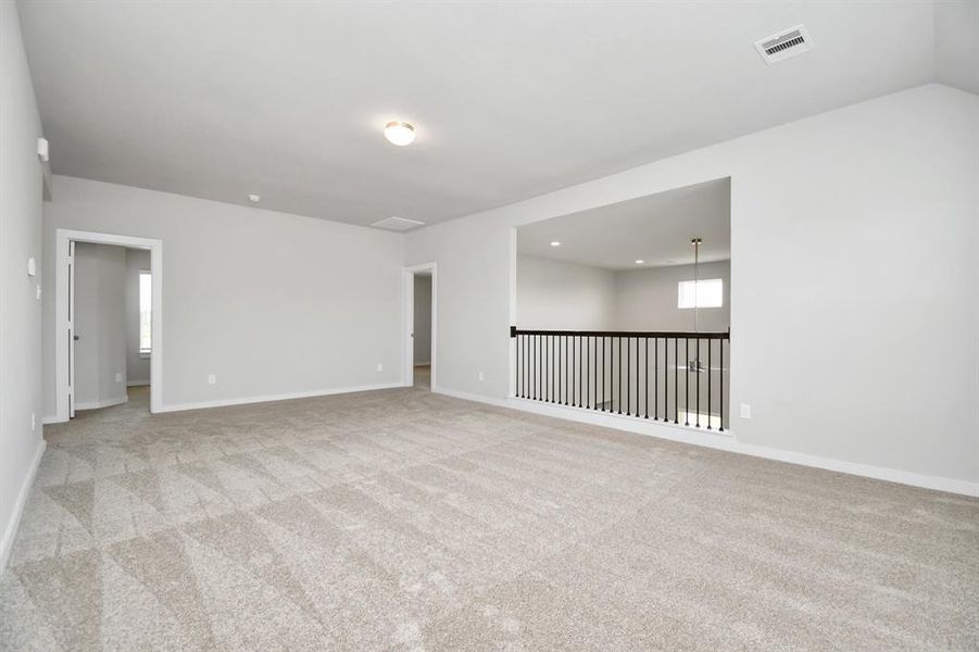 Ascend upstairs to be greeted by spacious game room along with secondary beds and baths. Sample photo of completed home with similar floor plan. Actual colors and selections may vary.