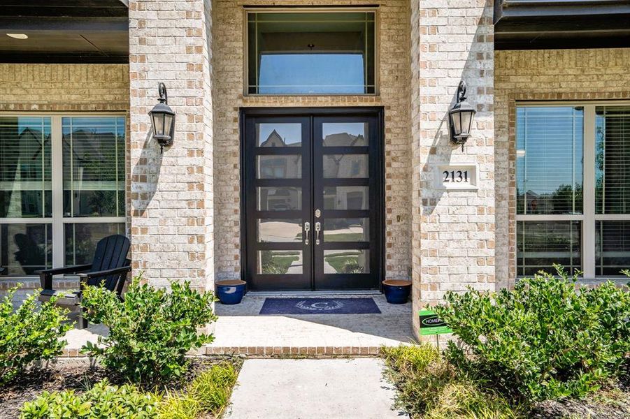 Double front door has 5-panel mistlite glass for soft light with privacy.