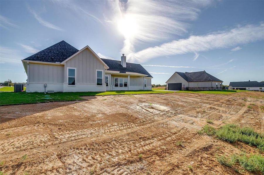 Back of house with a lawn and cooling unit