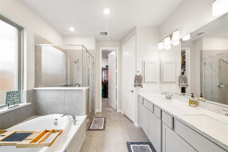 Super functional and sleek primary bathroom.  Dual sinks, soaking tub and separate shower.