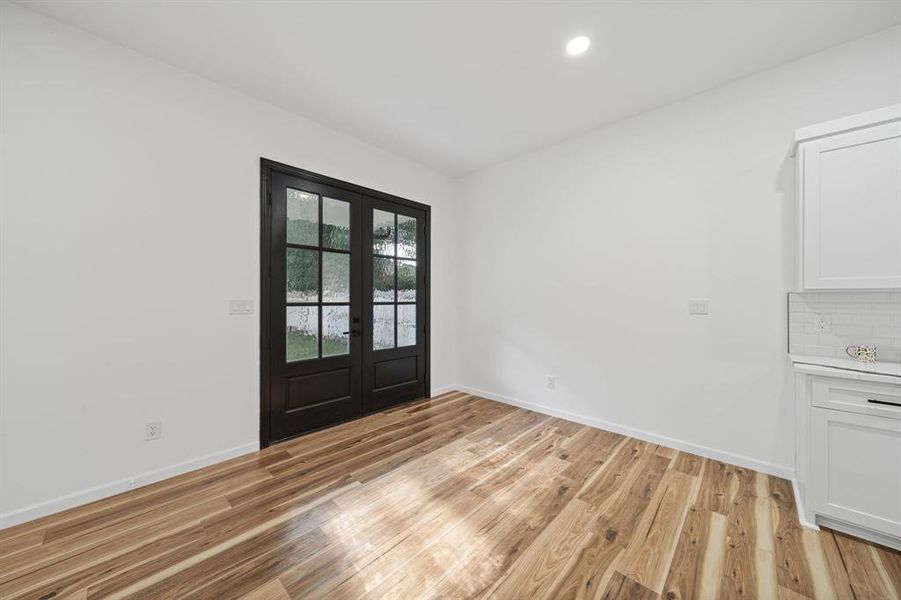 Entrance foyer with light hardwood / wood-style flooring and french doors