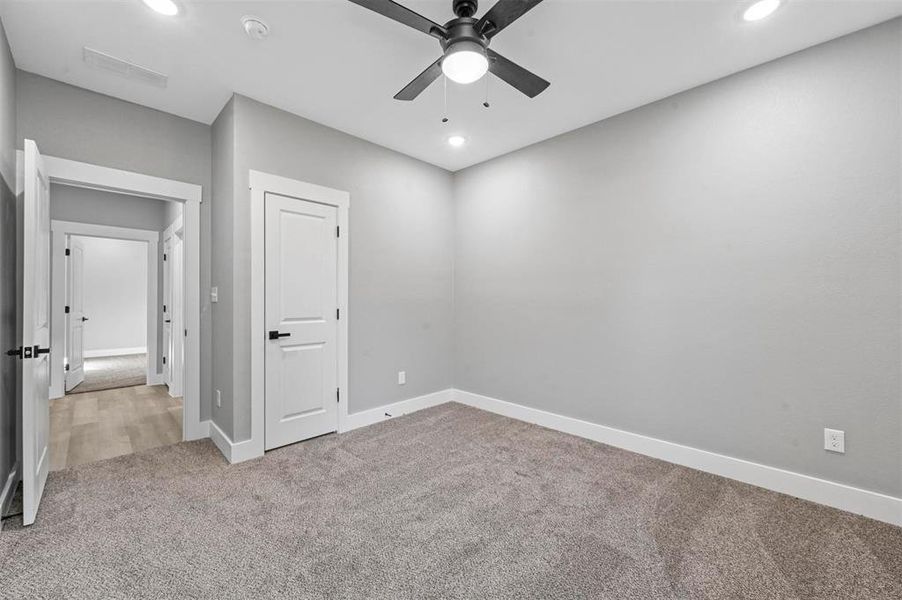 Unfurnished bedroom with a closet, ceiling fan, and carpet flooring