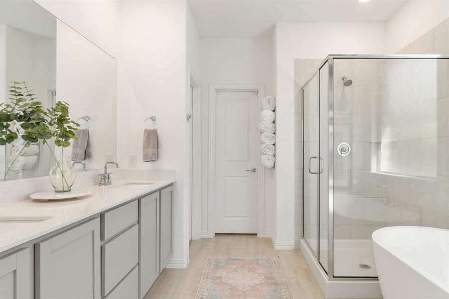 Bathroom featuring vanity, hardwood / wood-style flooring, and independent shower and bath